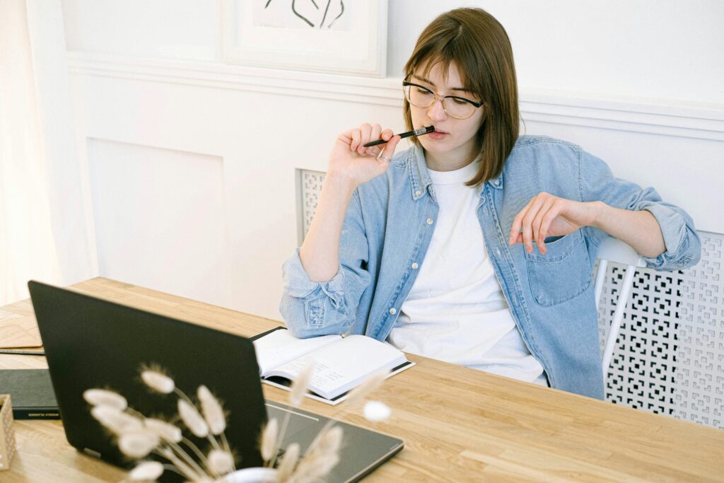 lady working at her desk thinking